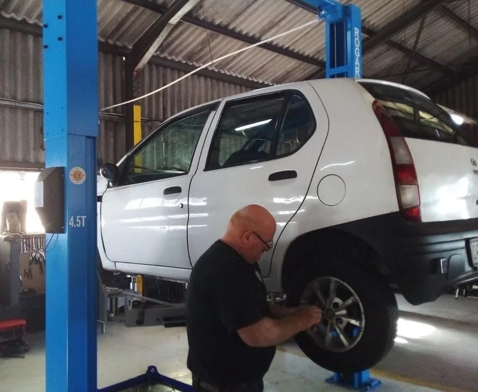 Vehicle being serviced on a workshop lift at Bullet Auto Service Station