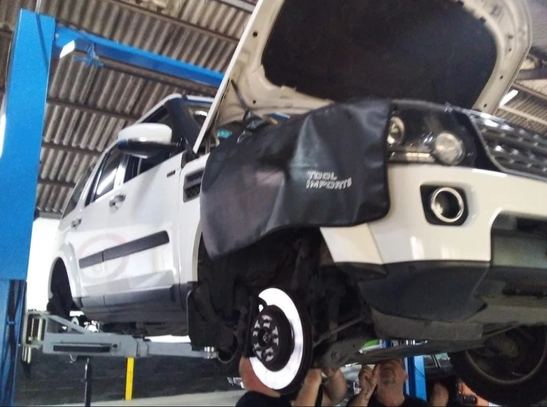Vehicle undergoing automotive service on a workshop lift at Bullet Auto Service Station