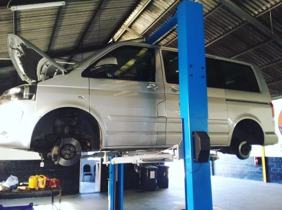 SUV on a workshop lift inside Bullet Auto Service Station